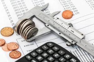 Measuring coins with a micronometer and calculator to demonstrate the benefits of chapter 13 bankruptcy in Columbus, Ohio over Chapter 7 bankruptcies